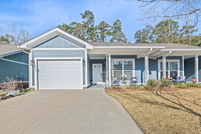 view of front facade with a garage, a front yard, and covered porch