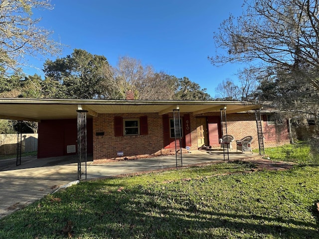 view of front of property featuring concrete driveway, an attached carport, crawl space, a front lawn, and brick siding