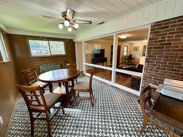 sunroom featuring wood ceiling, visible vents, and a ceiling fan