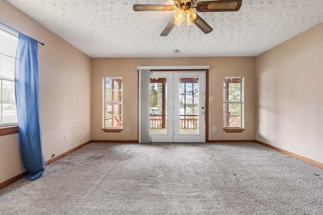 carpeted empty room with a textured ceiling and ceiling fan