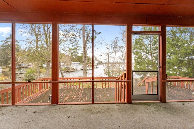 unfurnished sunroom with a water view