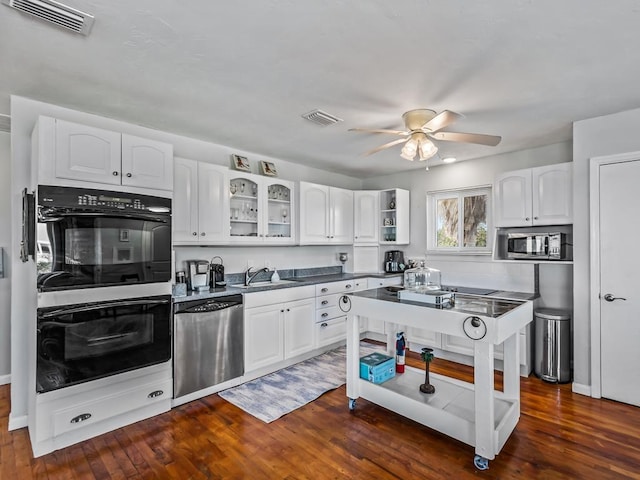 kitchen with ceiling fan, dark hardwood / wood-style flooring, white cabinetry, and stainless steel appliances