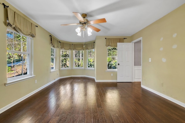 spare room featuring ceiling fan, hardwood / wood-style floors, and baseboards