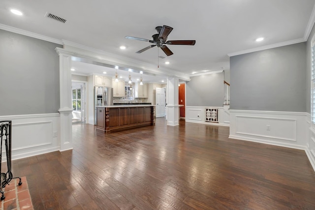 unfurnished living room featuring visible vents, ceiling fan, ornate columns, recessed lighting, and dark wood-type flooring