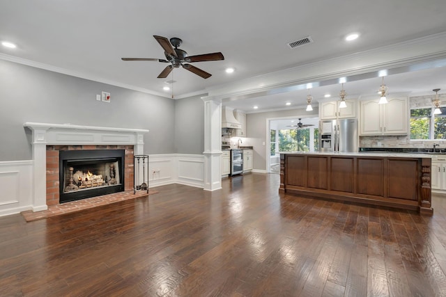 2953 Velda Dairy Rd, Tallahassee, FL 32309 - kitchen featuring stainless steel refrigerator with ice dispenser, ceiling fan, open floor plan, a brick fireplace, and dark wood-type flooring