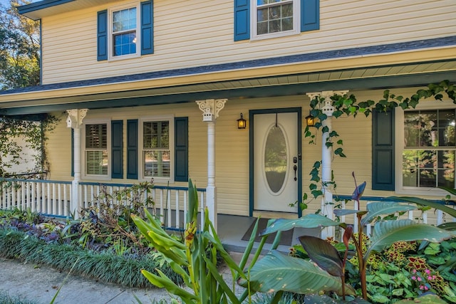 view of exterior entry with covered porch