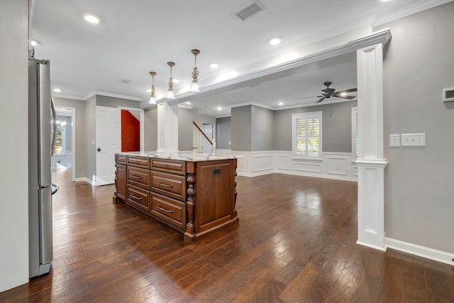 kitchen featuring visible vents, ceiling fan, freestanding refrigerator, dark wood finished floors, and brown cabinetry