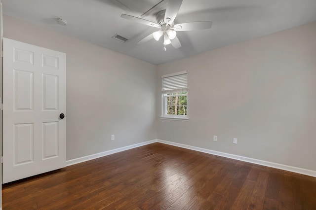 spare room with ceiling fan, baseboards, dark wood finished floors, and visible vents