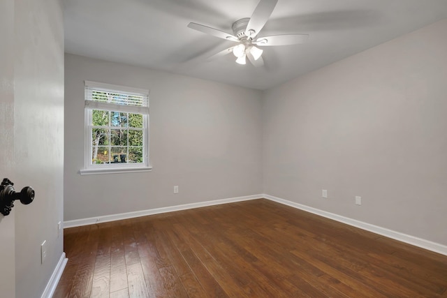 empty room with wood-type flooring, a ceiling fan, and baseboards