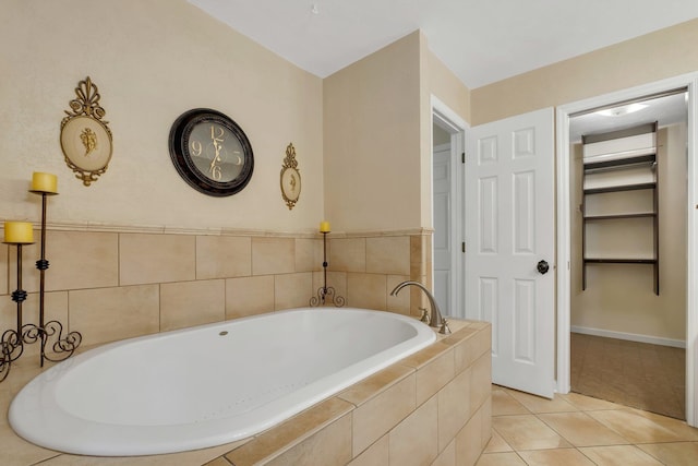 full bath featuring a bath and tile patterned flooring