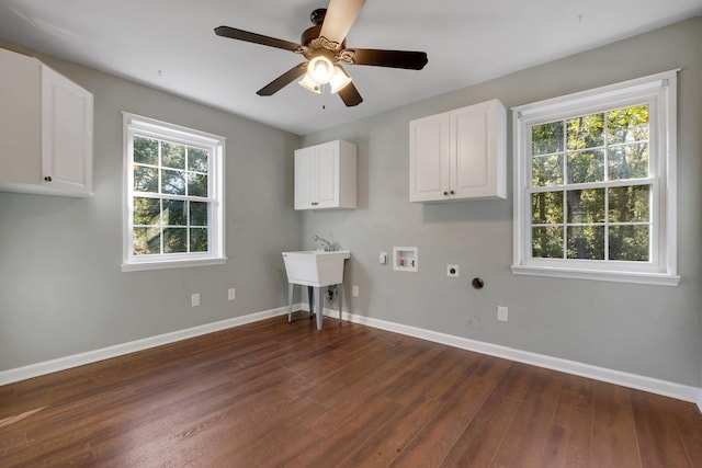 washroom with electric dryer hookup, baseboards, dark wood-style floors, hookup for a washing machine, and cabinet space
