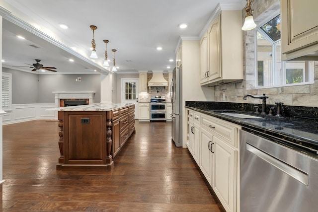 2953 Velda Dairy Rd, Tallahassee, FL 32309 - kitchen featuring appliances with stainless steel finishes, ornamental molding, a fireplace, backsplash, and custom range hood