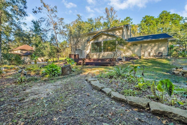rear view of property featuring a wooden deck