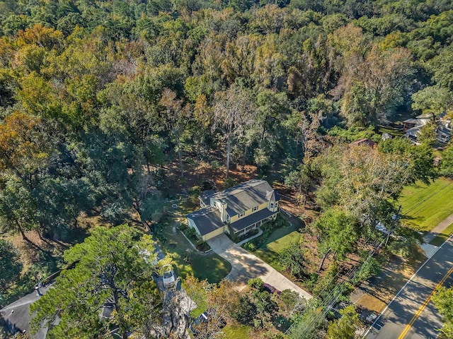 bird's eye view with a wooded view