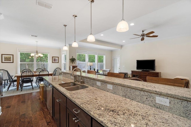 4516 Cavendish Ct, Tallahassee, FL 32309 - kitchen with dark wood-type flooring, crown molding, pendant lighting, dishwasher, and light stone counters