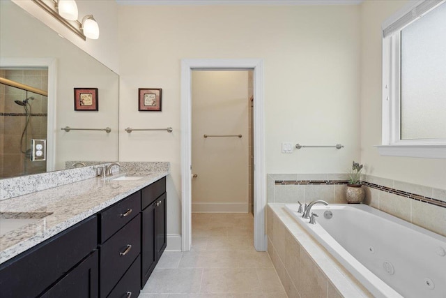 4516 Cavendish Ct, Tallahassee, FL 32309 - bathroom featuring a jetted tub, double vanity, a shower stall, and tile patterned flooring