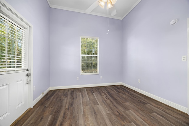 empty room featuring dark wood-type flooring, ceiling fan, and ornamental molding