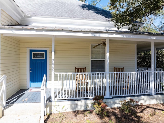 entrance to property featuring ceiling fan and a porch