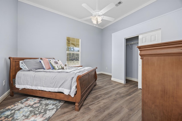 bedroom featuring dark wood-type flooring, ceiling fan, crown molding, and a closet