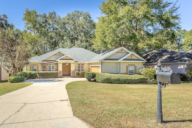 view of front of home with a front yard and a garage