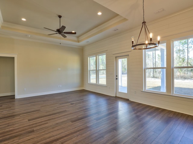 unfurnished dining area with recessed lighting, ornamental molding, ceiling fan with notable chandelier, a raised ceiling, and dark wood-type flooring