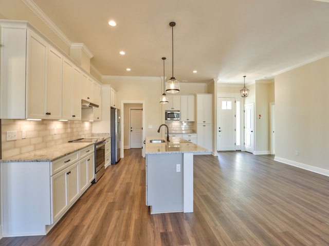 kitchen with appliances with stainless steel finishes, white cabinetry, and a sink
