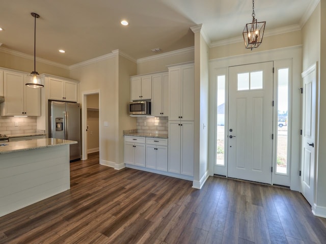 foyer featuring baseboards, recessed lighting, ornamental molding, and dark wood-type flooring