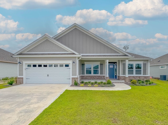 craftsman-style home with central air condition unit, a front yard, a porch, and a garage