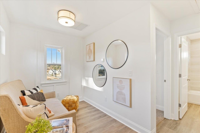 sitting room with light hardwood / wood-style flooring