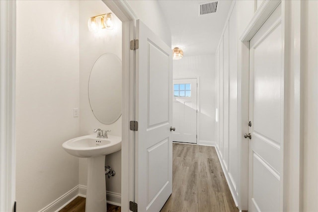 bathroom with wood-type flooring