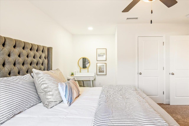 bedroom featuring ceiling fan and light carpet