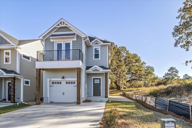 view of front of home featuring a garage and a balcony