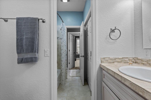 bathroom with tile patterned floors, vanity, decorative backsplash, and shower / bathtub combination with curtain