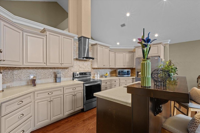 kitchen featuring backsplash, dark wood-type flooring, vaulted ceiling, wall chimney exhaust hood, and stainless steel appliances