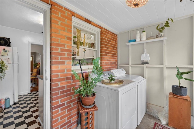 1454 S Gadsden St -, Unit Tallahassee, FL 32301 - laundry area with washer and clothes dryer, tile patterned floors, arched walkways, and brick wall