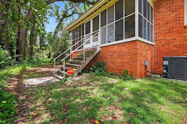 1454 S Gadsden St -, Unit Tallahassee, FL 32301 - view of property exterior featuring brick siding, a sunroom, and a yard