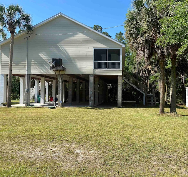 rear view of property with a yard