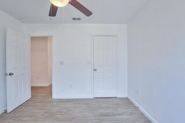 unfurnished bedroom with ceiling fan and light wood-type flooring