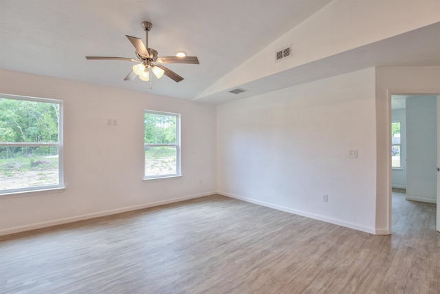 unfurnished room featuring ceiling fan, lofted ceiling, and light hardwood / wood-style flooring