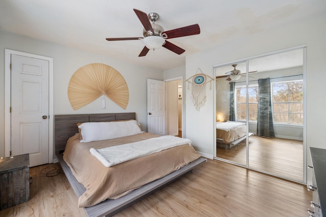 bedroom featuring ceiling fan, light wood-type flooring, and a closet