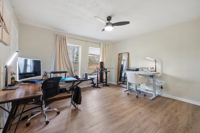 home office featuring ceiling fan, a textured ceiling, and light hardwood / wood-style floors