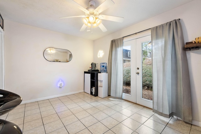 entryway featuring french doors, ceiling fan, and light tile patterned flooring