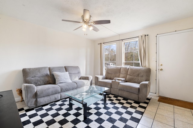 tiled living room with ceiling fan and a textured ceiling