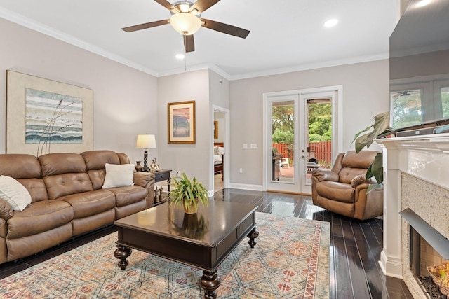 living room featuring a fireplace, french doors, crown molding, and dark hardwood / wood-style floors