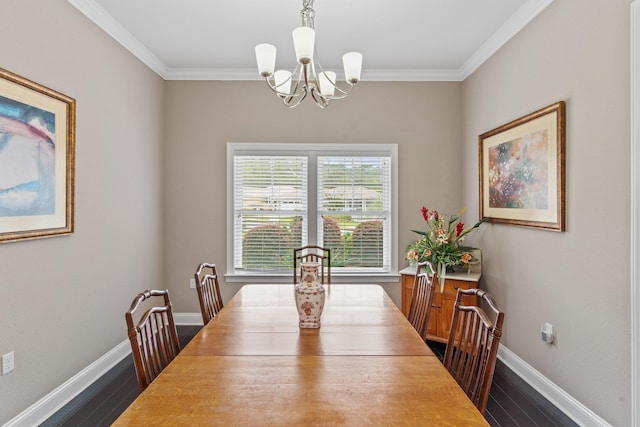 dining area with dark hardwood / wood-style flooring, crown molding, and a chandelier