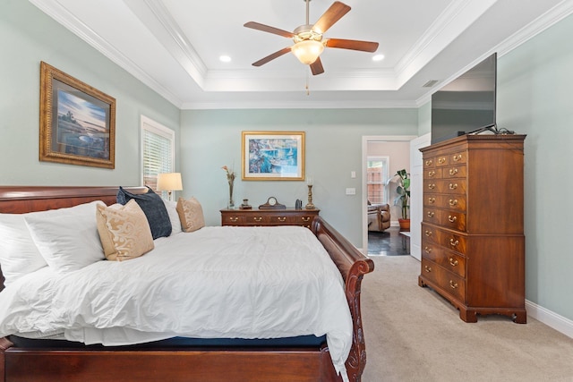 carpeted bedroom featuring ornamental molding, a raised ceiling, and ceiling fan