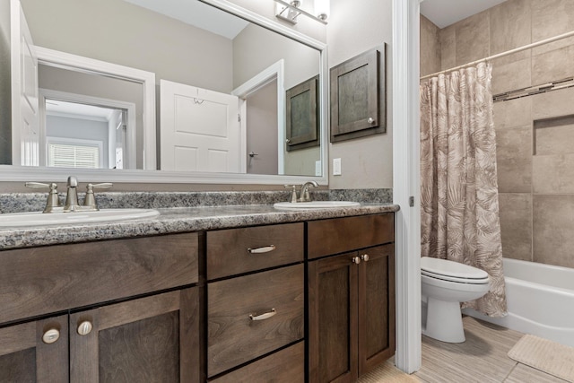 full bathroom with toilet, shower / bath combo with shower curtain, and vanity