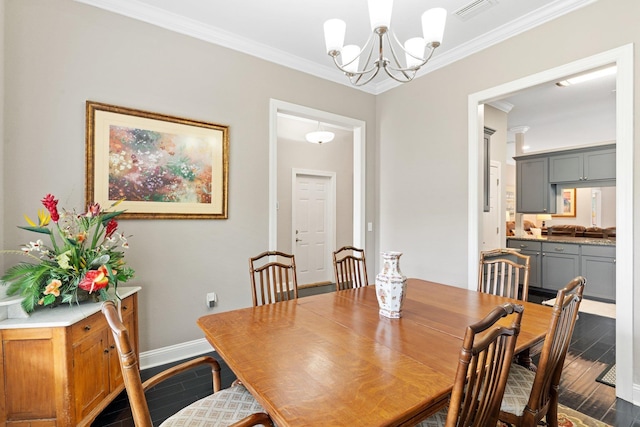 dining space with hardwood / wood-style floors, a notable chandelier, and crown molding