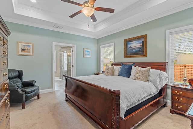 carpeted bedroom featuring ensuite bathroom, a raised ceiling, ceiling fan, and multiple windows