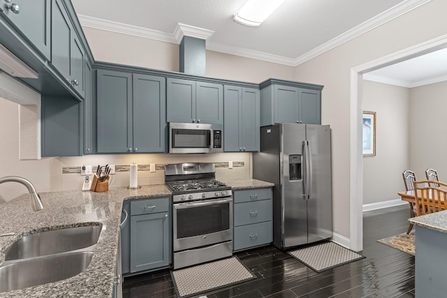 kitchen featuring stainless steel appliances, sink, ornamental molding, and light stone countertops